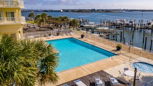 A pool area with a view of the marina and water.