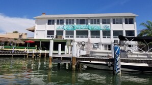 A waterfront building with a sign reading "White Elephant Pub." - Bohemian Sunrise  (Englewood)