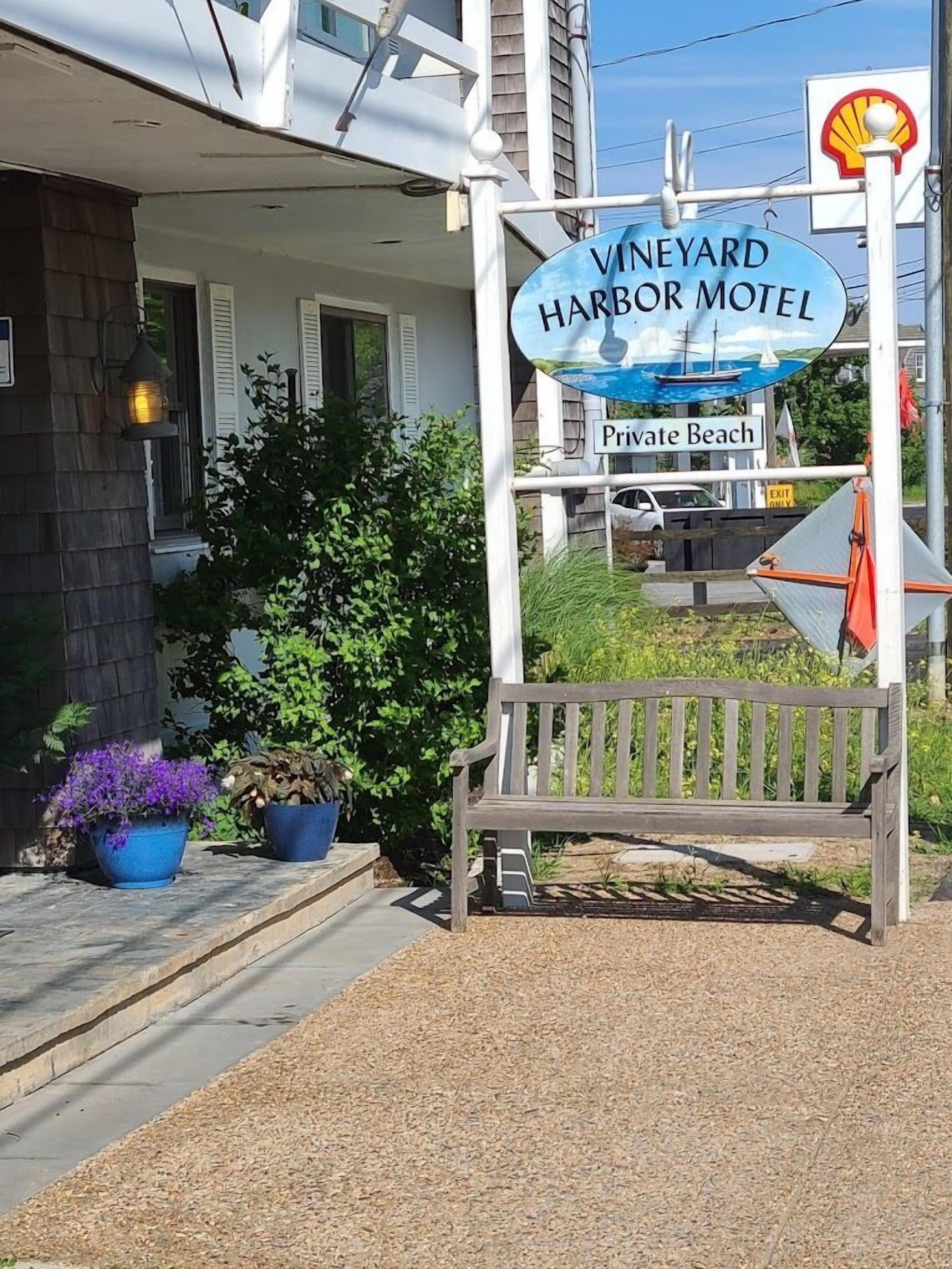 A sign for Vineyard Harbor Motel with a private beach.