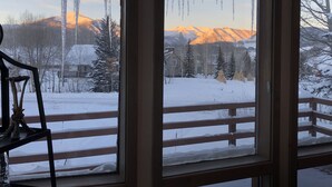 A room with a large window overlooking a snowy landscape with mountains and trees. - Mt. Crested Butte Full House, 3 Bedroom/3.5 Bath+Loft, Hot Tub, Shuttle  to Ski (Crested Butte)