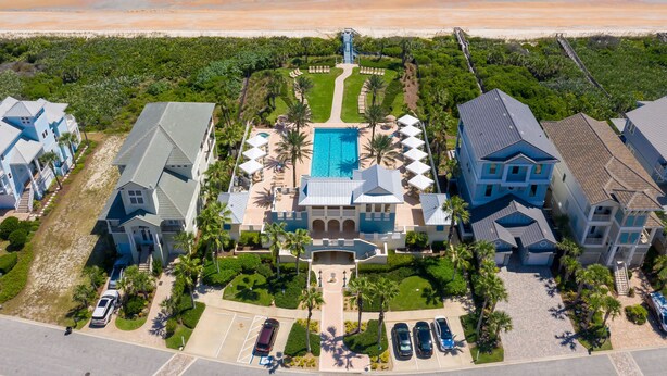 A resort with a central pool, beachfront view, and multiple guest villas. - New Furnishings, Direct Oceanfront Corner Unit 721! (Palm Coast)