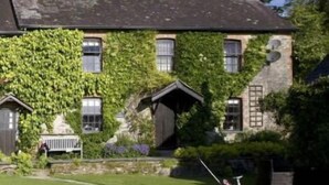 A stone house with ivy-covered walls, a lawn, and a small garden. - The Farmhouse - perfect for families to share, private hot-tub and fabulous shared leisure facilitie (Boncath,)