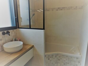 Bathtub, hair dryer, towels, soap