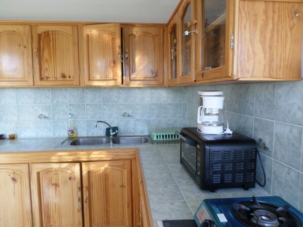 Fridge, microwave, stovetop, coffee/tea maker