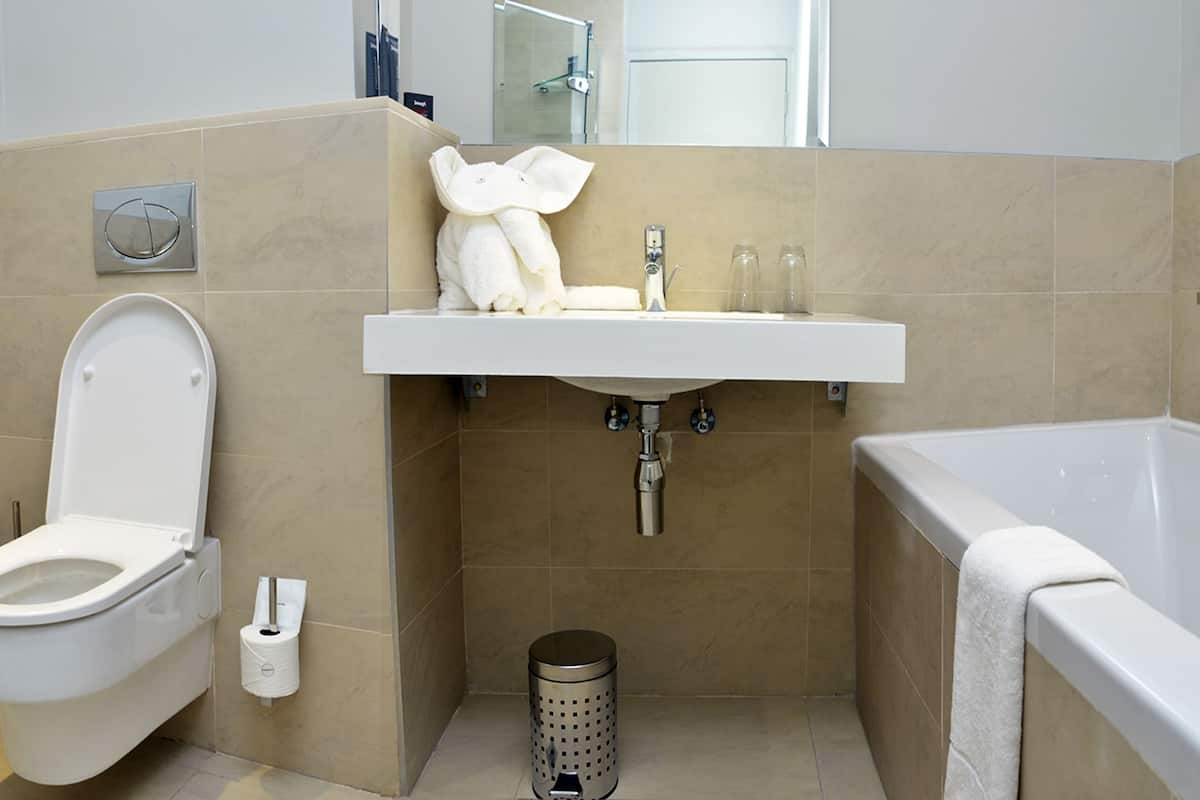 standard twin room | bathroom | separate bathtub and shower, hair dryer, towels, soap