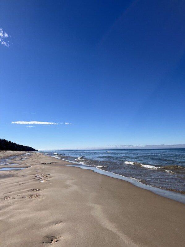 A beach with a clear sky and calm sea.