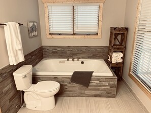 Bathtub, jetted tub, hair dryer, towels