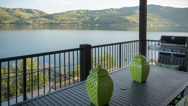A balcony with a view of a lake and hills, a grill, and two green vases. - WATER FRONT - PRIVATE POOL AND DOCK W/BUOY (Manson)