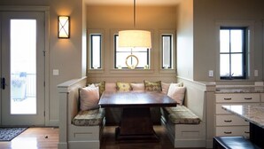 A cozy seating area with a bench and cushioned seats, a pendant light, and a window with a view. - WATER FRONT - PRIVATE POOL AND DOCK W/BUOY (Manson)