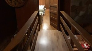 A wooden staircase leading to a room with a bed and a wooden door. - Rent house villarrica-pucon (eclipse 2020) (Villarrica)
