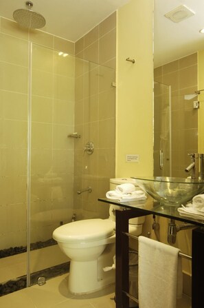 A modern bathroom with a glass-enclosed shower, a glass bowl sink, and a toilet. - Boracay Sandcastles The Apartments (Boracay Island)