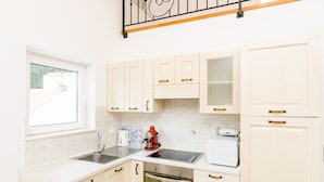 A kitchen with light wooden cabinets, a stainless steel sink, a coffee maker, and a toaster. - Cozy Duplex Apartment A2, in a Stone Built House, Sunset Beach Near Dubrovnik (Dubrovnik)