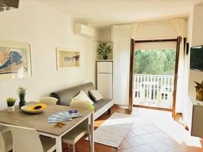 Apartment, 1 Bedroom, Balcony, Garden View | Living room | TV - Bright sea Front Apartment With Balcony (San Michele al Tagliamento)