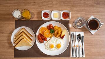 A breakfast plate with toast, eggs, and fruit, accompanied by condiments and a cup of coffee on a wooden table.