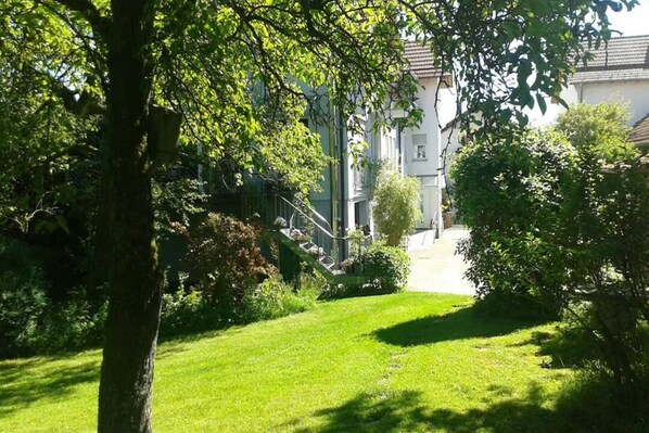 A well-maintained garden with a pathway leading to a building.