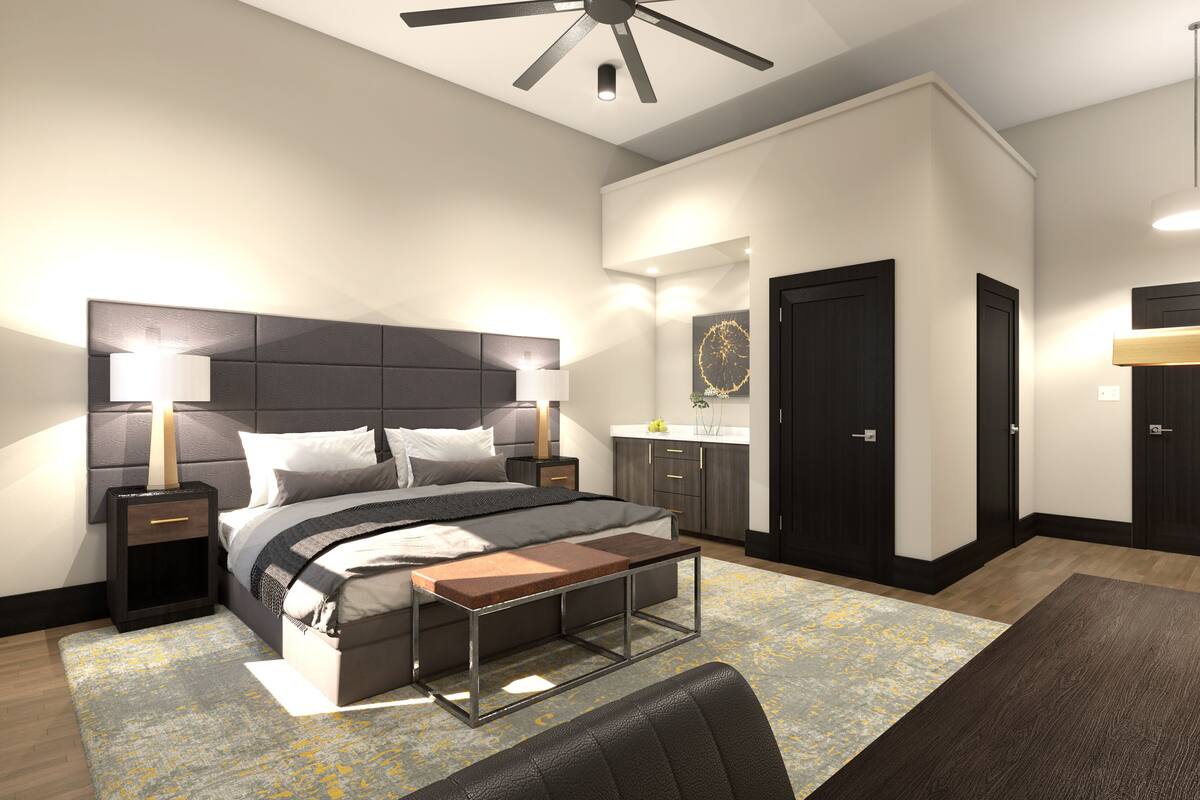 A modern bedroom with a bed, bedside tables, a desk, a chair, and a ceiling fan.