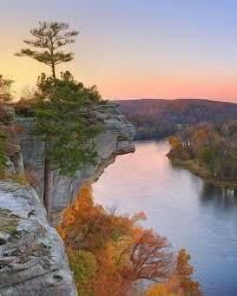 A natural landscape with a river, a cliff, and a tree.