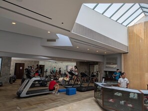 A spacious indoor gym with treadmills, stationary bikes, and a yoga area. - Princess Mundo Imperial (Acapulco)
