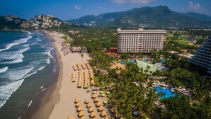 A coastal resort with a beach, a large hotel, and a swimming pool. - Princess Mundo Imperial (Acapulco)