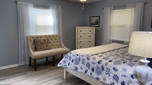 A bedroom with a bed, a chair, a dresser, and a ceiling fan. - A perfect place in Central Florida for boating, fishing, or a relaxing vacation! (Lake Wales)