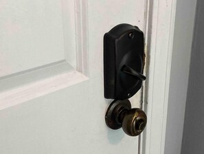 A classic entrance with a doorbell and doorknob.