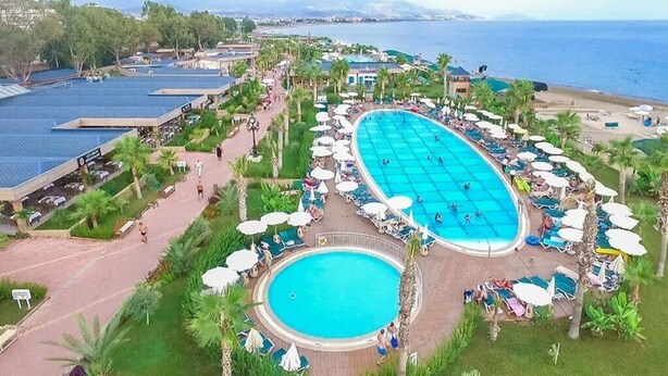 A resort with a large central pool, smaller surrounding pools, and a beach area. - Eftalia Marin Resort (Alanya)