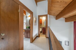 Enter a cozy room with a bed and a small plant, featuring a window with an outside view.