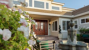 A house with a front door, a bench, and a fountain. - Sunset Manor: Luxury Wine Country Estate; Pool, Views, Steps to Wilson Creek (Temecula)
