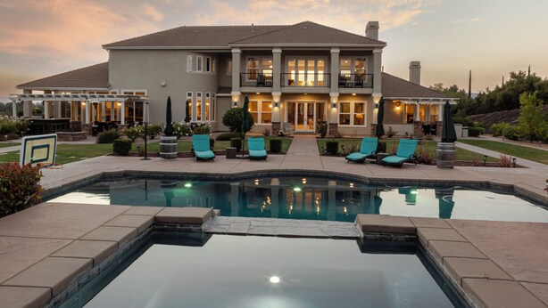 A two-story house with a swimming pool, outdoor seating, and a well-maintained garden. - Sunset Manor: Luxury Wine Country Estate; Pool, Views, Steps to Wilson Creek (Temecula)