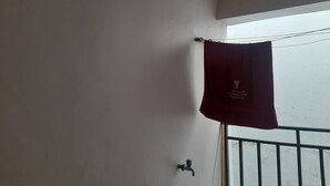 A bathroom with a towel hanging on a rack, a faucet, and a window with a view. - South B 1 bedroom rental furnished apartment  (Nairobi)