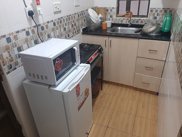 Fridge, microwave, stovetop, cookware/dishes/utensils - South B 1 bedroom rental furnished apartment (Nairobi)