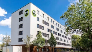 A modern B&B hotel with a white facade, multiple windows, and a paved courtyard. - B&B Hotel Hamburg-Nord (Hamburg)