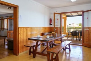 Enjoy casual dining in this cozy space with a wooden table and benches.