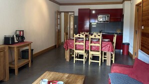 A compact living space with a dining area, a kitchenette, and a seating area with a coffee table. - Ski-In/Ski-Out Apartment, 6 Guests, Terrace & Private Ensuite (Montgenèvre)