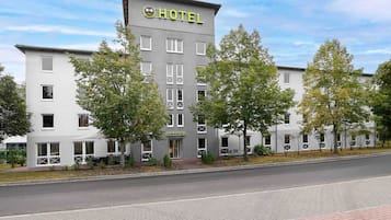 A hotel with a modern design, featuring a reception area and multiple windows.