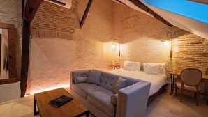 Une chambre confortable avec un lit, un canapé, une table et une chaise.