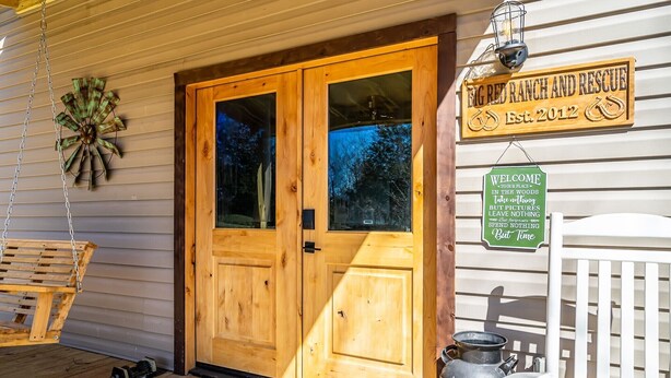 A wooden door with a sign above it stating "Big Red Ranch and Rescue Established 2012". - Skip the Steep Roads! Family Cabin Hot Tub Near PF (Sevierville)