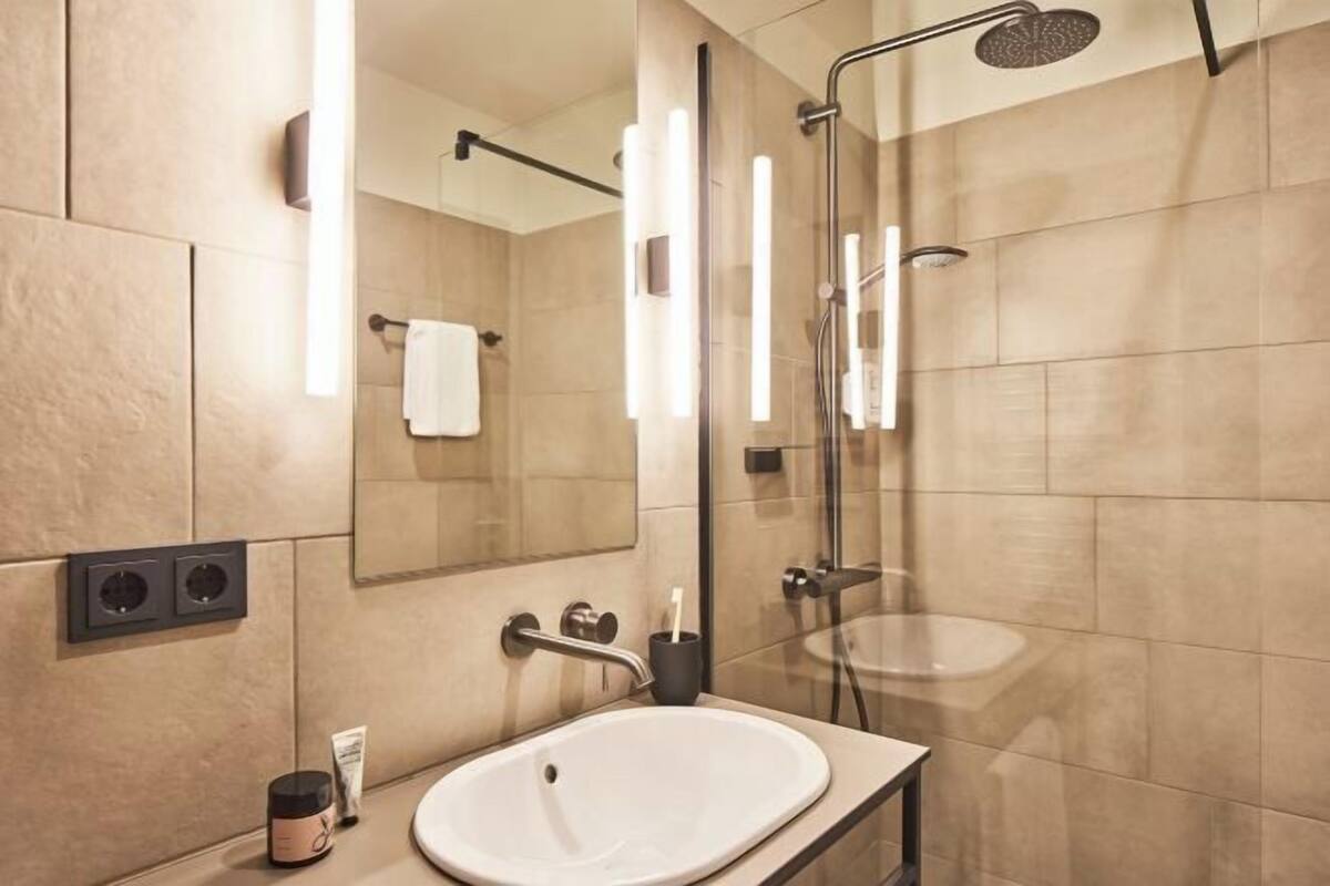 Shower, rainfall showerhead, hair dryer, towels