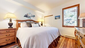Cozy bedroom with a large bed, nightstands, and a dresser, offering a comfortable sleeping arrangement and ample storage.