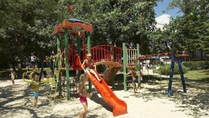 A playground with a slide and climbing structures. - Kompas (Balchik)