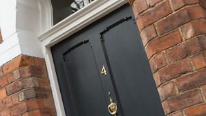 A black door with the number 4, a brass knocker, and a brass mail slot. - 4 St Martins Lane. Luxurious Central York Town House. Newly refurbished (York)