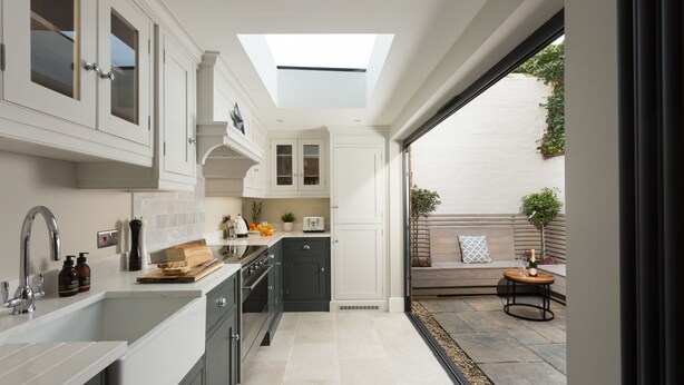 A modern kitchen with a skylight, built-in appliances, and a view to a patio area. - 4 St Martins Lane. Luxurious Central York Town House. Newly refurbished (York)