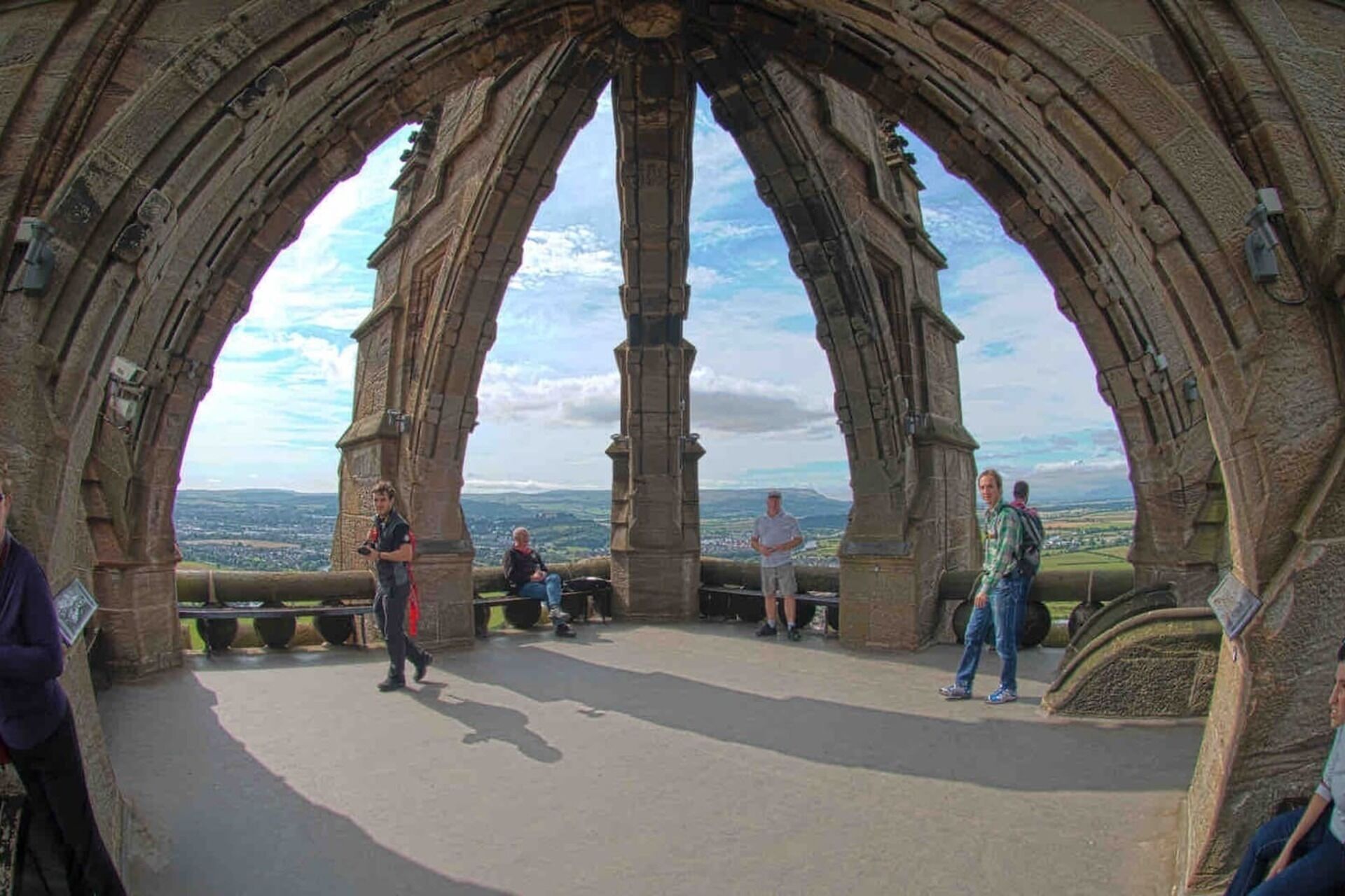 A stone archway with a view of the landscape.