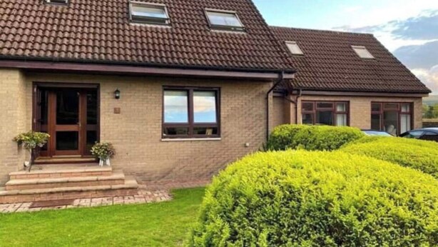 A two-story house with a tiled roof, a front door, and a small porch with steps. - 1 Bed House - Central, Free Parking, Wifi (Stirling)