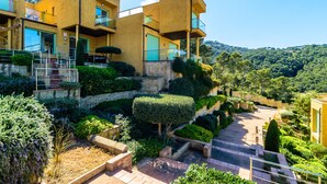 A modern building with multiple balconies and a landscaped garden. - Nice townhouse with comunity pool and sea views. (Begur)