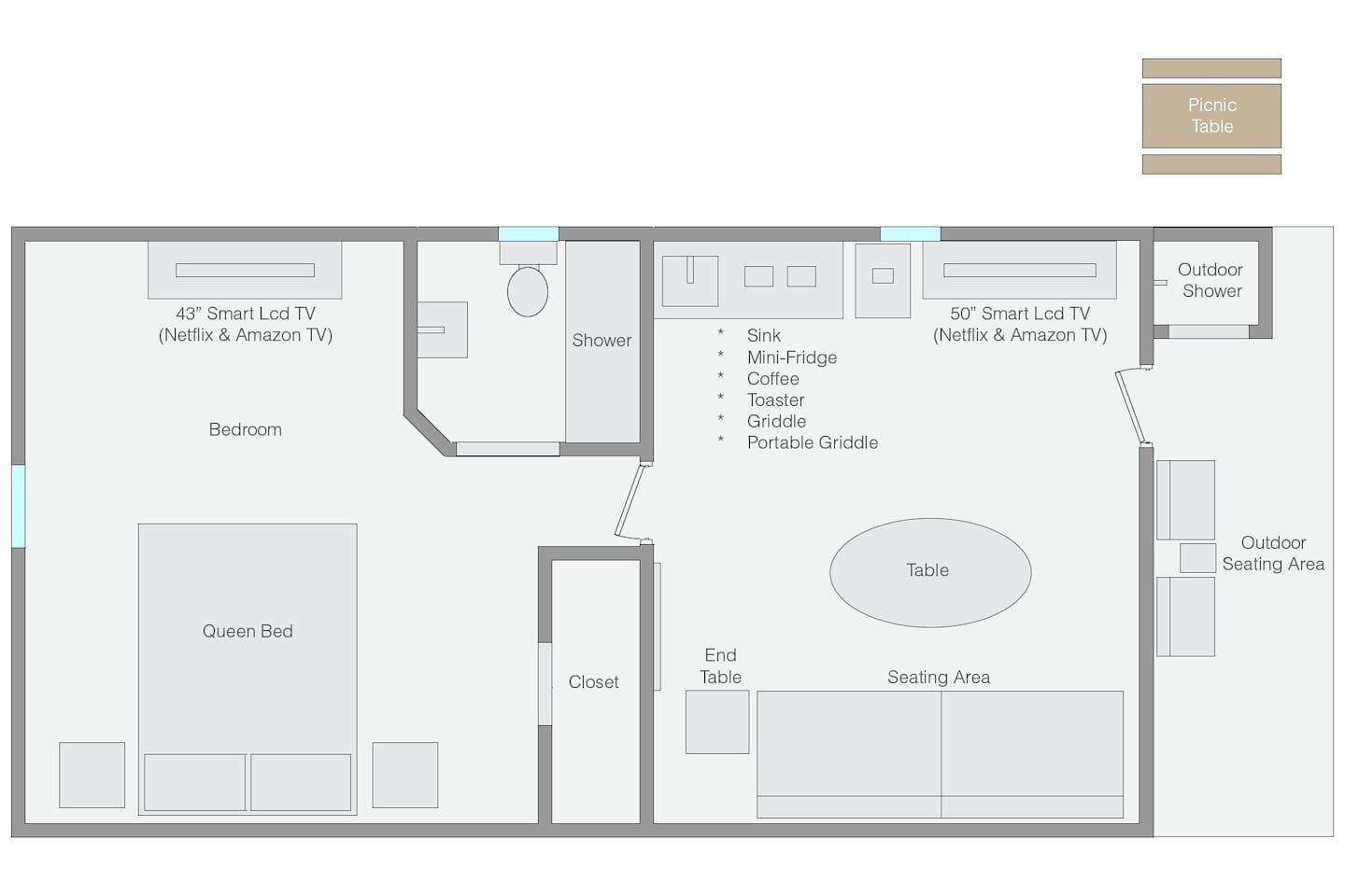 A hotel room layout with a queen bed, a large seating area, an outdoor shower, and a picnic table.