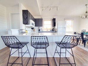 Enjoy cooking in this well-equipped kitchen with a central island and modern appliances.