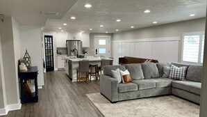 A modern kitchen with white cabinets, a stainless steel refrigerator, and a central island. - Location, comfort and cleanliness.<br>Whole basement 1600-plus square feet.  (LEHI CITY)