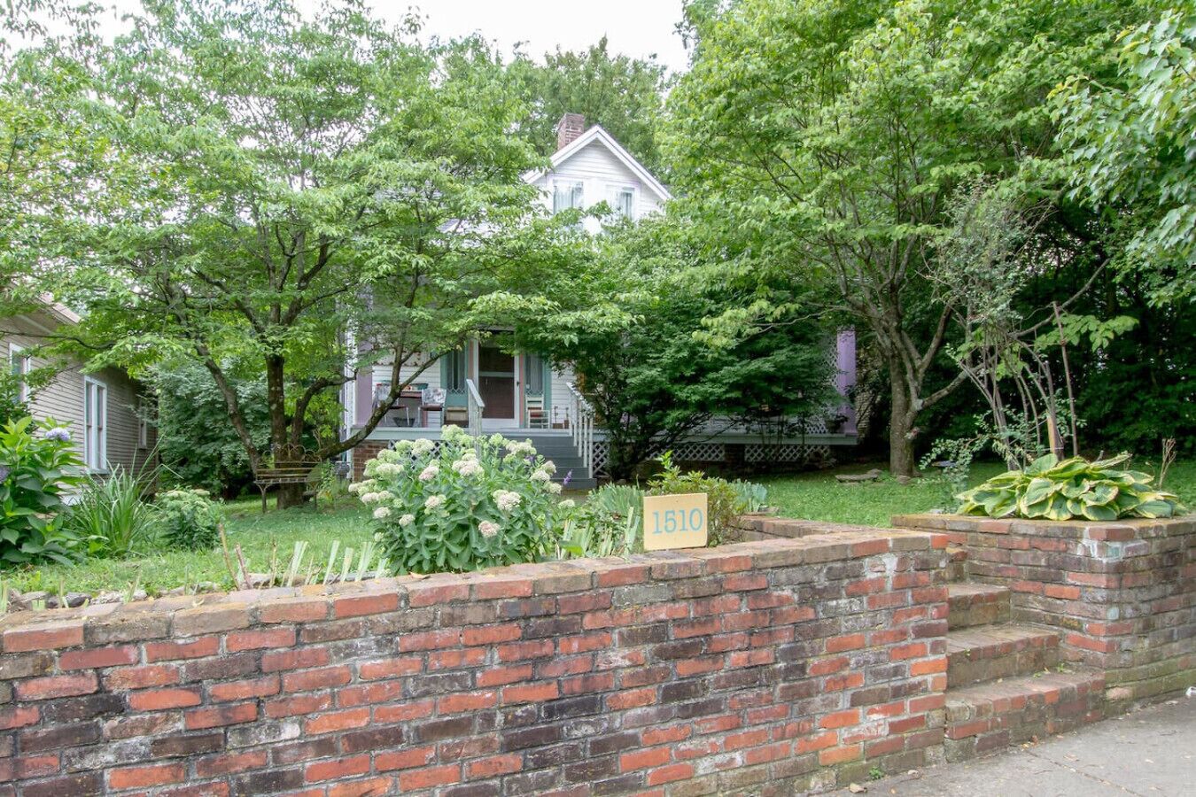 A two-story house with a brick front wall and a mailbox labeled "1510".