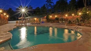 A swimming pool with a deck area, surrounded by trees and a wooden fence. - Specials! Stunning Views+Location. 4 King Beds w/ en suite. Hot Tub, Games! (Sevierville)